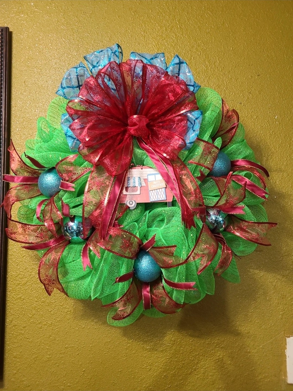 Festive Green Holiday Wreath with Red and Blue Accents